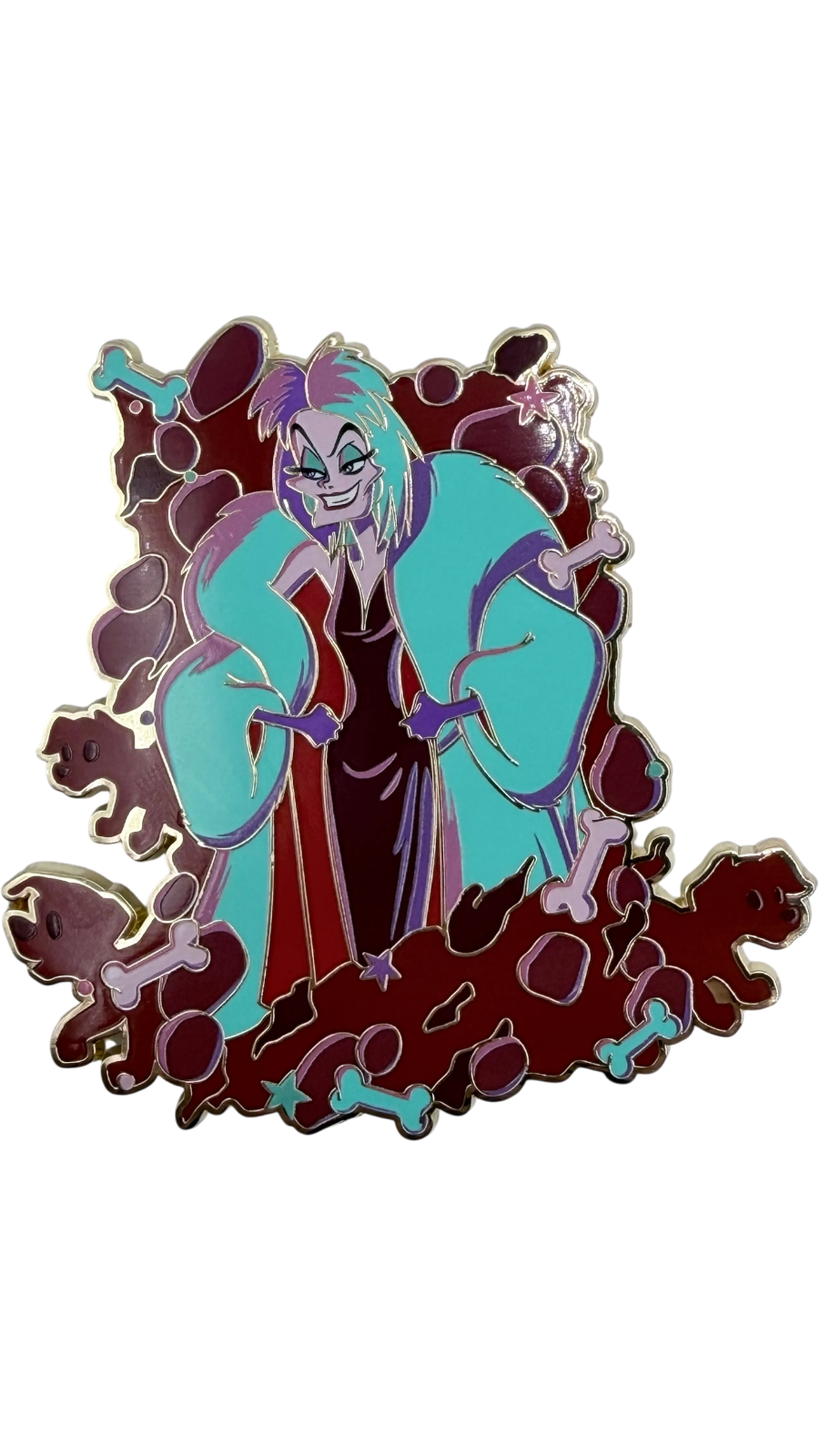 Graidan Collectibles Cruella De Vil enamel pin with teal coat and bone motifs on a gold-tone metal finish.