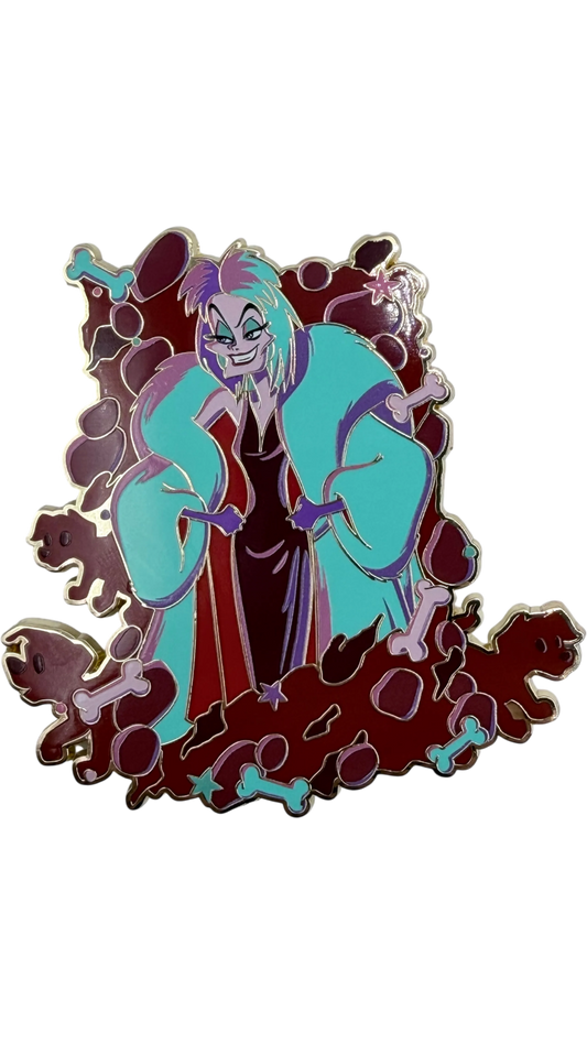 Graidan Collectibles Cruella De Vil enamel pin with teal coat and bone motifs on a gold-tone metal finish.