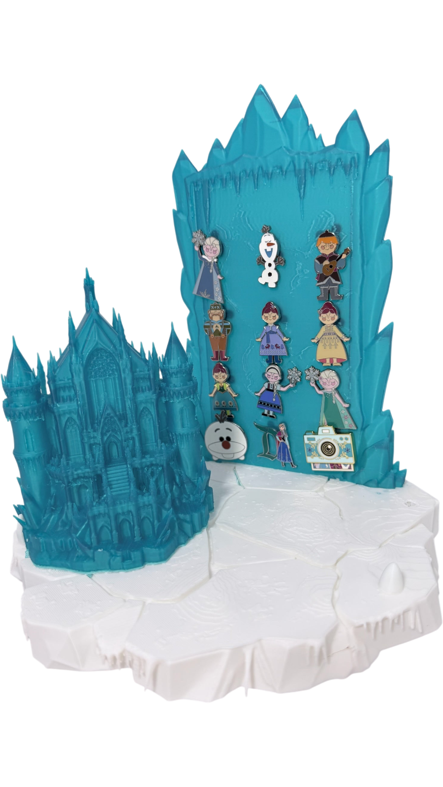 Graidan Collectibles 3D-printed translucent blue ice castle pin display stand with snowy base and character enamel pins.