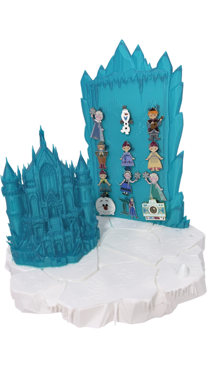 Graidan Collectibles 3D-printed translucent blue ice castle pin display stand with snowy base and character enamel pins.