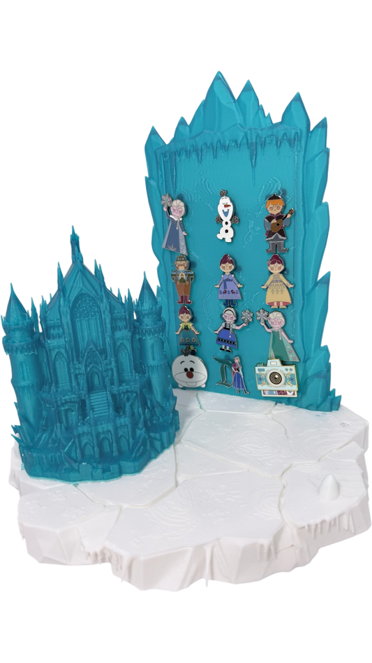 Graidan Collectibles 3D-printed translucent blue ice castle pin display stand with snowy base and character enamel pins.
